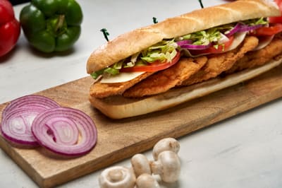 A crispy chicken finger sub with lettuce and tomato