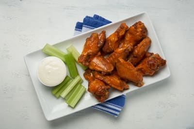 Chicken wings served with celery and blue cheese dressing