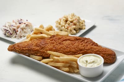 A beer battered fish fry with french fries, cole slaw and macaroni salad