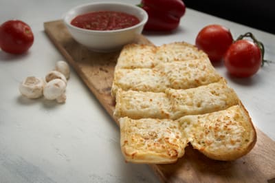 Garlic bread with melted cheese, cut into strips