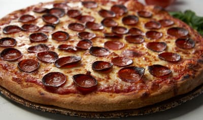 A pepperoni pizza, close up on the crust and edge